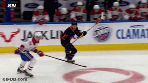 Hockey Game In Front Of Jack Link Sign GIF