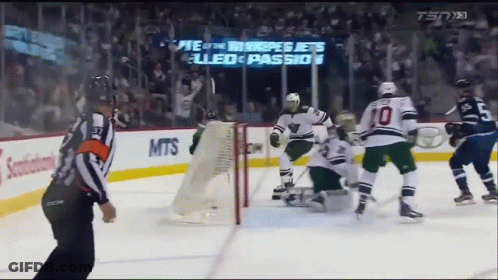 Hockey Game In Front Of Jets Sign GIF