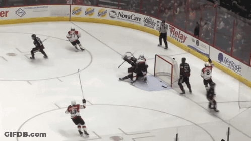 Hockey Game In Front Of Novacare Advertisement GIF