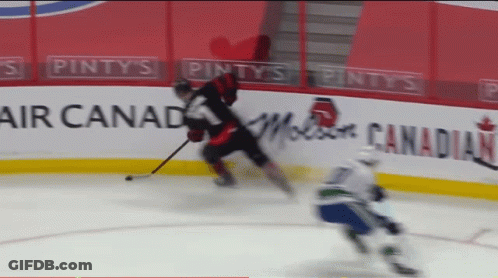 Hockey Game In Front Of Pinty's Air Canada Banner GIF