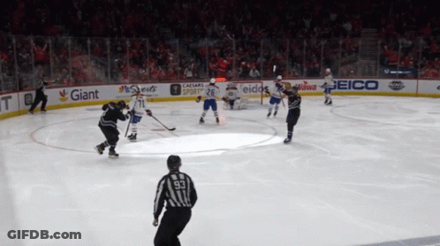 Hockey Game In Stadium With Giant And Geico Ads GIF