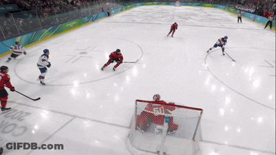 Hockey Game On Rink With Olympic Rings GIF