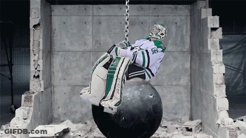 Hockey Goalie Hanging From Wrecking Ball Chain GIF