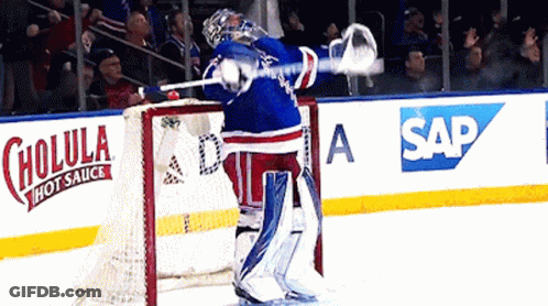 Hockey Goalie In Front Of Cholula Hot Sauce Ad GIF