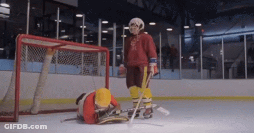 Hockey Goalie Standing Next To Fallen Player GIF