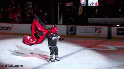 Hockey Mascot Holding Red And Black Flag With Number 2 GIF