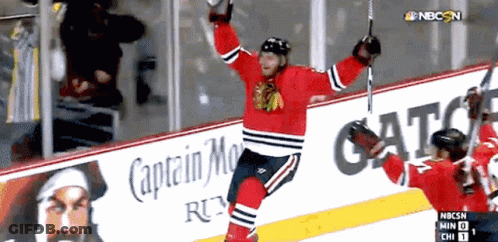 Hockey Player Celebrates Goal In Front Of Captain Morgan Ad GIF