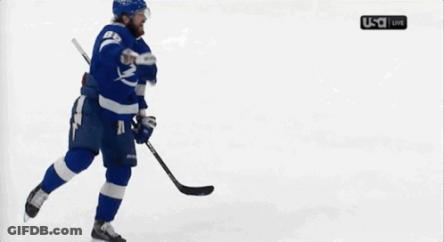 Hockey Player Holding Puck In Front Of USA Live Screen GIF