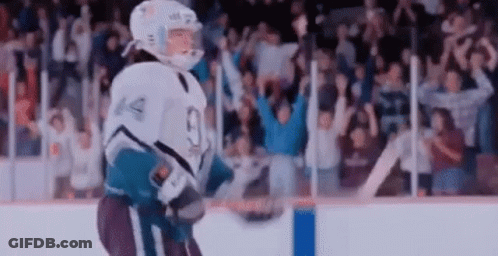 Hockey Player Holding Puck On Ice GIF