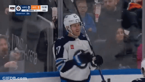 Hockey Player Holding Stick In Front Of Crowd GIF