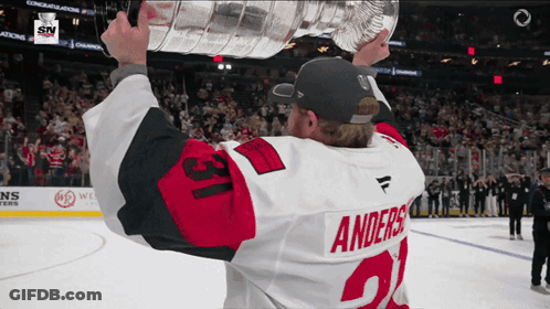 Hockey Player Holding Trophy Number 21 GIF