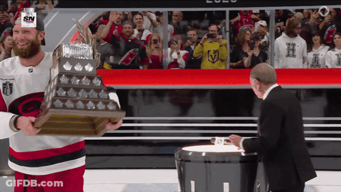 Hockey Player Holding Trophy With SN On Hat GIF