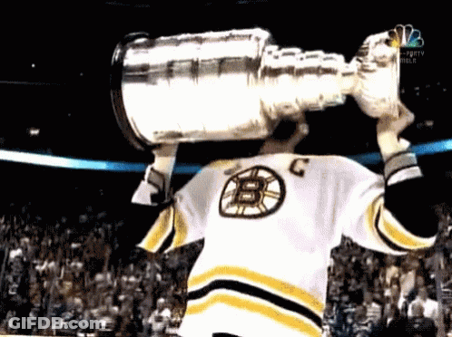 Hockey Player In B Jersey Holding Trophy Over Head GIF