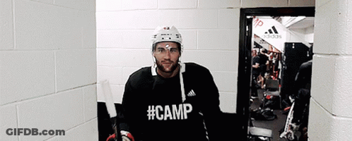 Hockey Player In Black Camp Shirt In Hallway GIF