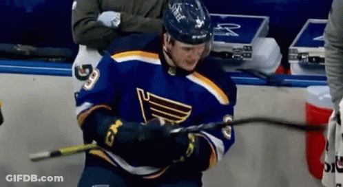 Hockey Player In Blue Jersey Holding Stick GIF