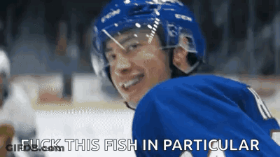 Hockey Player In Blue Jersey Smiling Says Fuck This Fish In Particular GIF