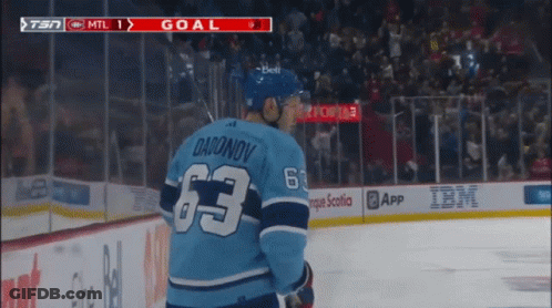 Hockey Player In Blue Jersey With Number 63 GIF