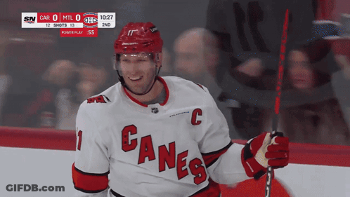 Hockey Player In Canes Jersey Smiling GIF