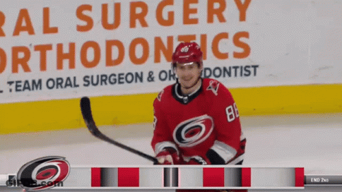 Hockey Player In Front Of Oral Surgery Ad GIF