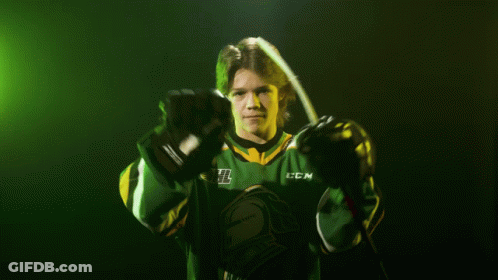 Hockey Player In Green And Yellow CCM Jersey Holding Hockey Stick GIF
