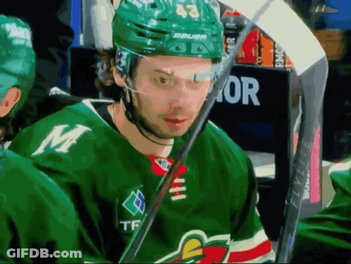 Hockey Player In Green Jersey With M GIF