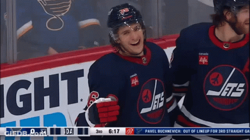Hockey Player In Jets Jersey In Front Of Canada Life Sign GIF