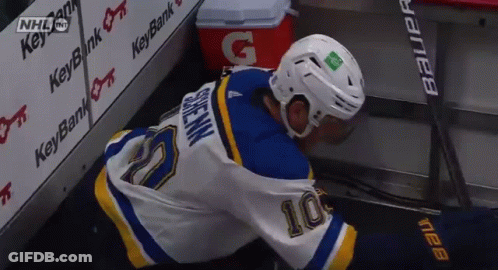 Hockey Player In Number 10 Jersey Lying On Ice GIF