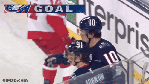 Hockey Player In Number 10 Jersey Next To Another Player GIF