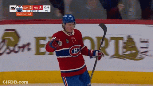 Hockey Player In Red White And Blue Jersey Holding Stick GIF
