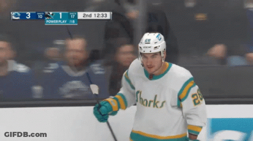Hockey Player In Sharks Jersey Holding Puck GIF