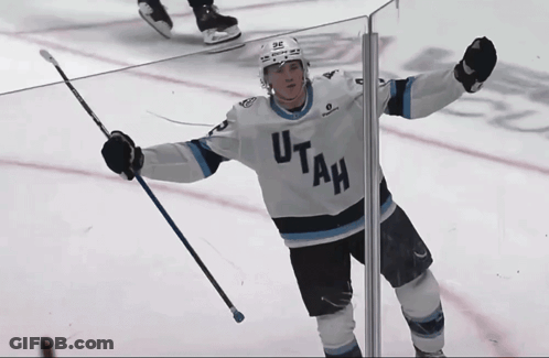Hockey Player In Utah Jersey Holding Up Arms GIF