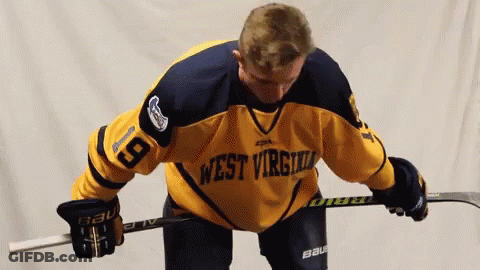 Hockey Player In West Virginia Jersey Holding Stick GIF