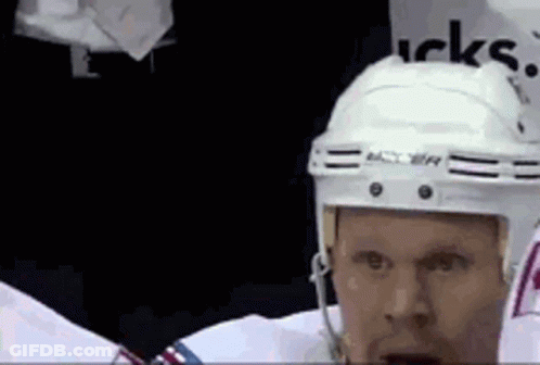 Hockey Player In White Helmet Standing In Locker Room GIF