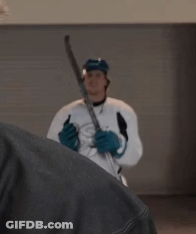 Hockey Player In White Jersey And Blue Gloves Holding Stick GIF