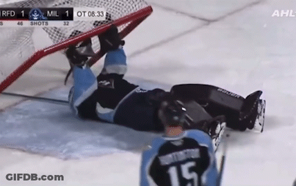 Hockey Player Lying On Ice In Front Of Goal GIF