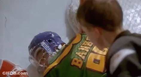 Hockey Player Lying On Ice With Helmet Next To Boy GIF