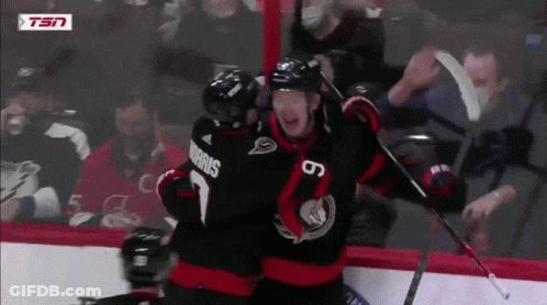 Hockey Player Morris Hugging Another Player On Ice GIF