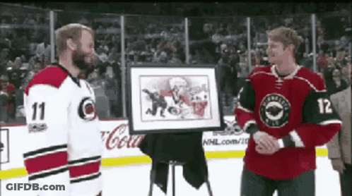 Hockey Player Number 12 Holding Framed Picture GIF