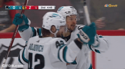 Hockey Player Number 12 Hugging Another Player GIF