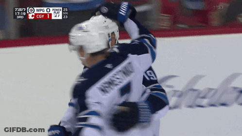 Hockey Player Number 19 Being Hugged GIF