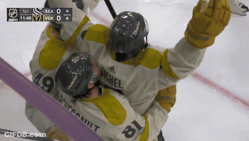 Hockey Player Number 19 Hugging Another GIF