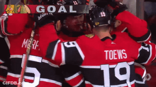 Hockey Player Number 19 Hugging Another GIF