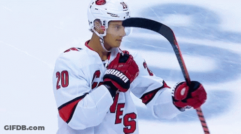 Hockey Player Number 20 Holding Hockey Stick GIF