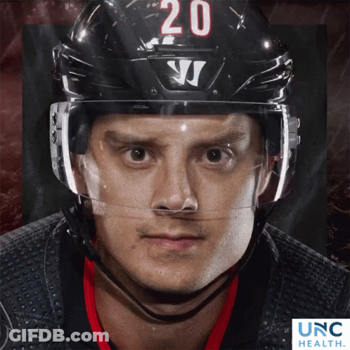 Hockey Player Number 20 On Helmet Looking At Camera GIF