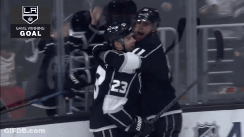 Hockey Player Number 23 Hugging Another Player GIF