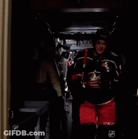 Hockey Player Number 3 Carrying Stick GIF