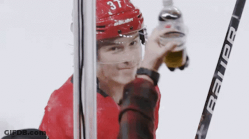 Hockey Player Number 37 Holding Bauer Stick GIF