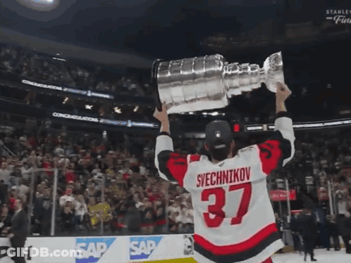 Hockey Player Number 37 Holding Trophy GIF
