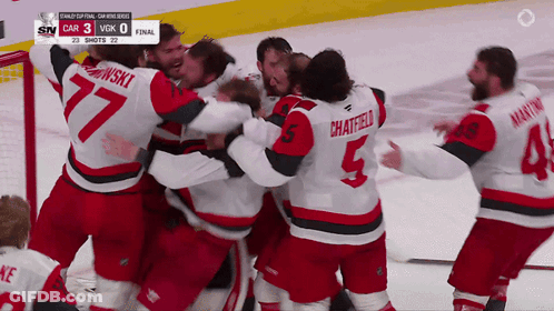 Hockey Player Number 5 Surrounded By Players GIF