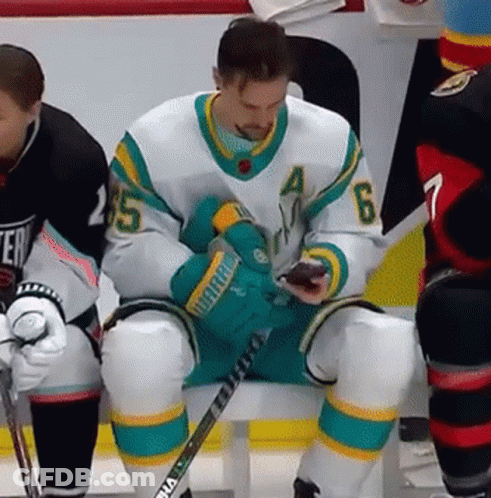 Hockey Player Number 6 Looking At Phone GIF